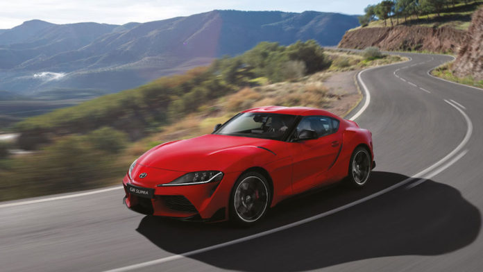 Toyota Supra driving on curved road